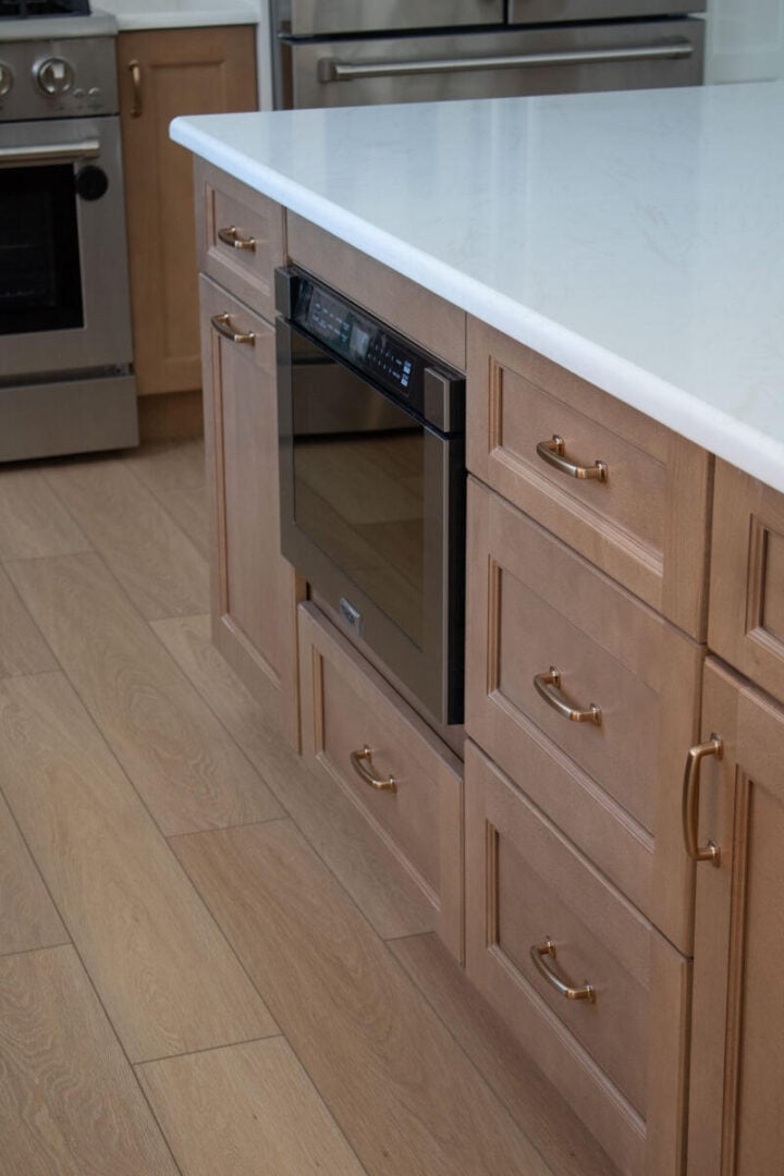 kitchen island with microwave drawer - white and brown kitchen cabinets ideas