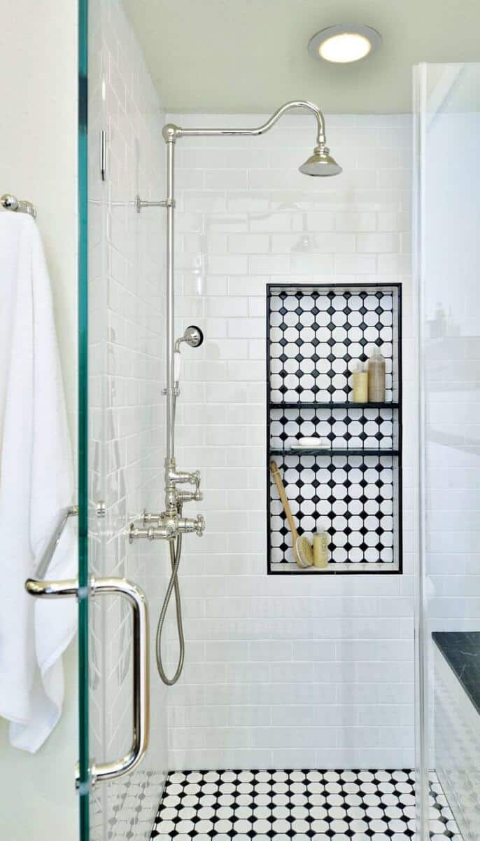 patterned shower niche with black and white tiles