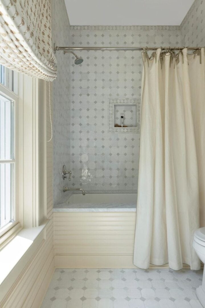 patterned shower tile in bathtub with matching floor tile