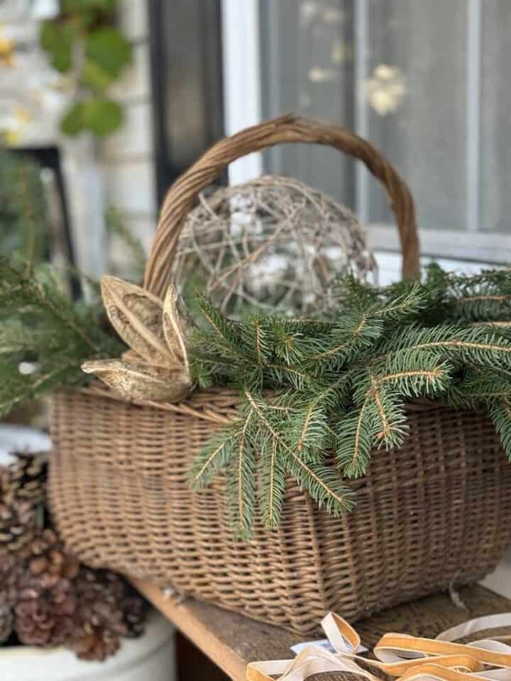 porch planter ideas for Christmas basket full of evergreen branches